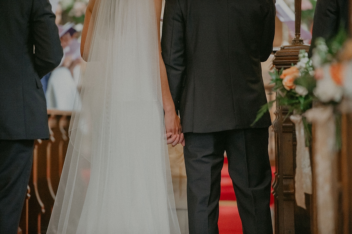 bride groom holding hands aisle church wedding essex