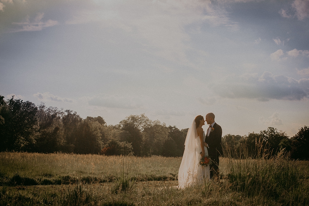hay field braxted park essex bride groom kissing couple portrait photography