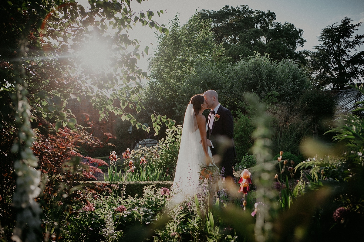 sun flare golden walled garden couple portraits pose bride groom 
