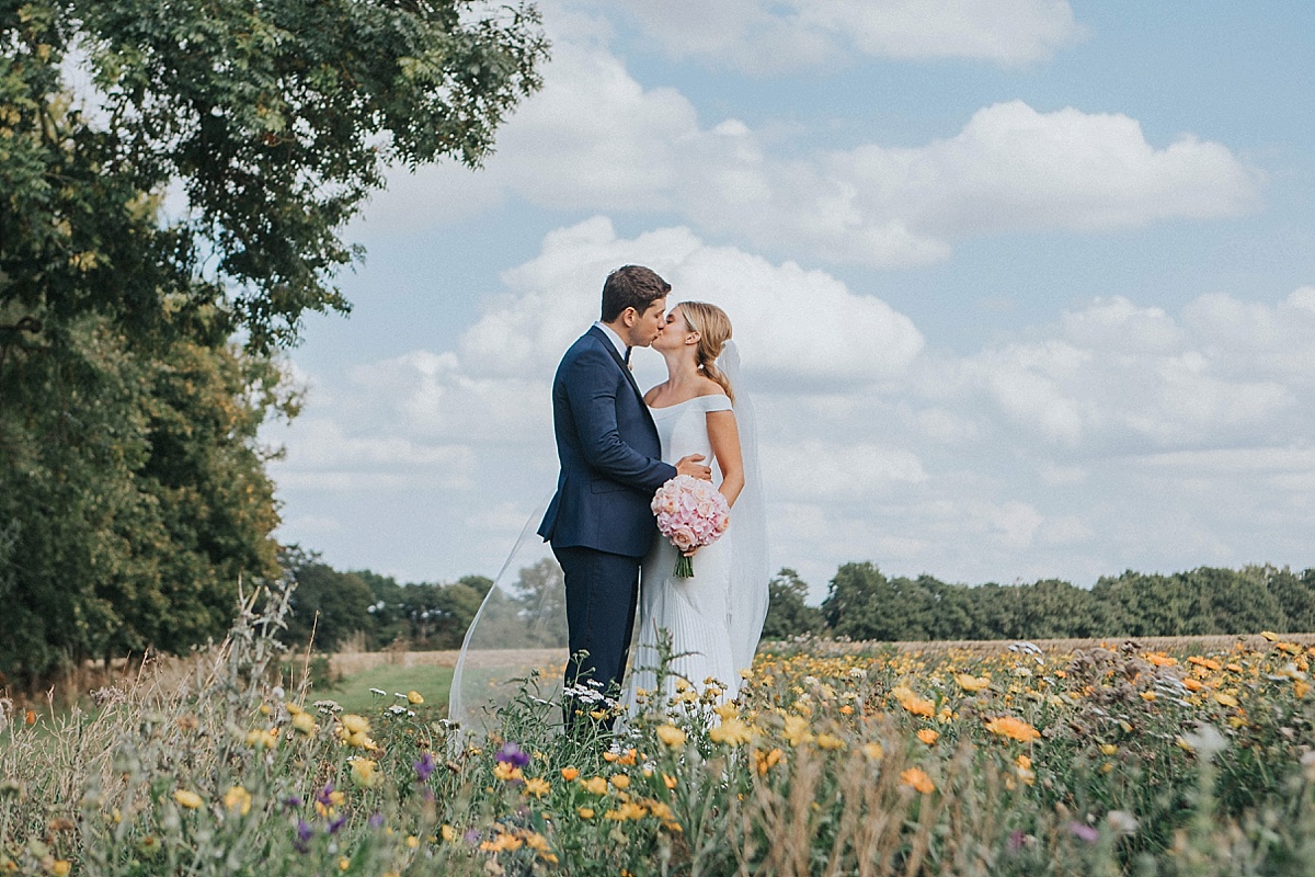 granary estate wedding suffolk wildflower field couple portrait