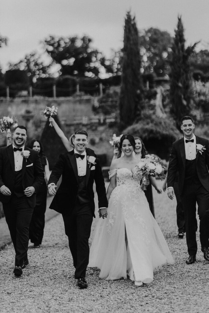 Newlyweds celebrating with bridal party at Oxnead Hall