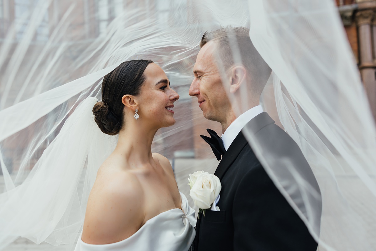 Under the veil image of elegant bride and groom by Essex wedding photographer